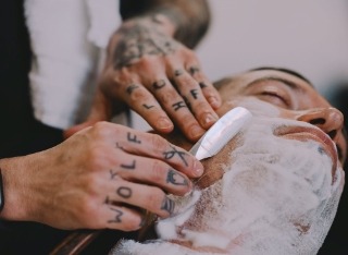 Licensed professional refining straight-razor technique during the 50-hour barber refresher