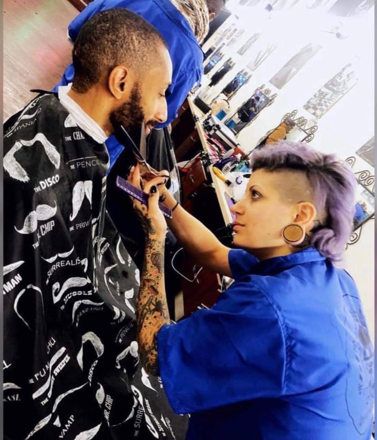 Barber detailing client's hairline