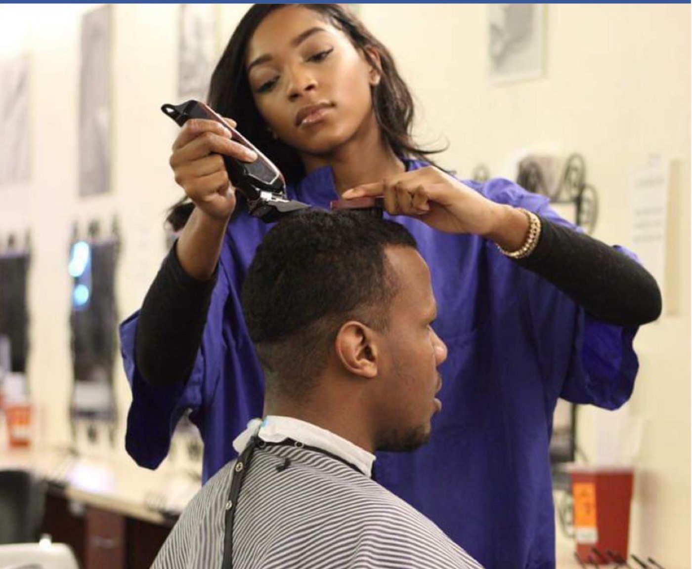 Student cutting client's hair with clippers