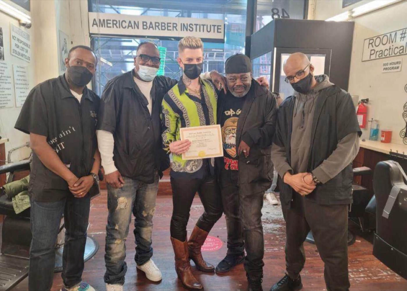 Five people posing with certificate